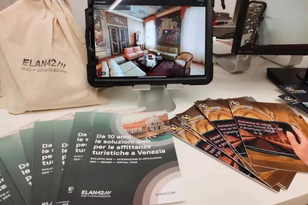 L'immagine mostra materiali promozionali di ELAN42, sponsor Gold di "Inform-Azione", con brochure e.